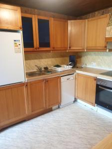 a kitchen with wooden cabinets and a white refrigerator at st Veit 