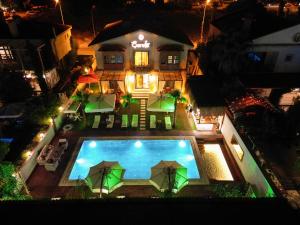 an aerial view of a house with a swimming pool at night at Şerefe Hotel Alaçatı in Alaçatı