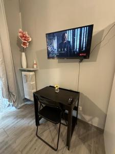 a living room with a table and a tv on the wall at B&B girasole in Verona