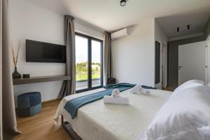a bedroom with a large bed with a large window at Villa Arestea in Vodnjan +41 photos