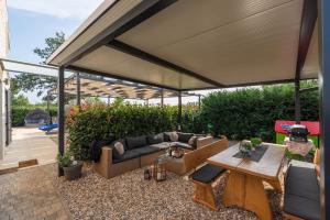 a large patio with a couch and a table at Libra in Nova Vas