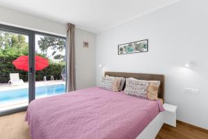 a bedroom with a bed and a swimming pool at Libra in Nova Vas +29 photos