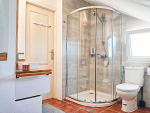a bathroom with a shower and a toilet at Selwo Studio in Estepona