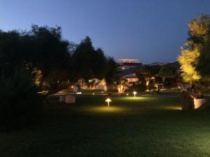a park at night with lights in the grass at Cala Rosa Club Hotel in Stintino