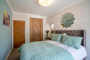 a bedroom with a bed and a mirror on the wall at 10 St Marys in York