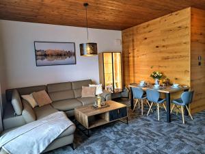 a living room with a couch and a table at Apartmány Hrabušice in Hrabušice