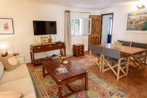 a living room with a table and a dining room at Maison Magdeleine in Saint-Tropez