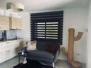 a living room with a couch and a window at Ocean shore apartment 2 in Puerto de Santiago