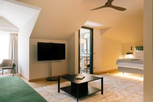 a living room with a bed and a tv in a room at Pestana Rua Augusta Lisboa in Lisbon