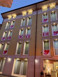 a building with hearts on the side of it at Residenza Agnello D'Oro in Bussolengo