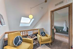 a living room with two chairs and a mirror at The Golf View, boutique Galena getaway! in Galena