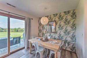 a dining room with a table and a large window at The Golf View, boutique Galena getaway! in Galena