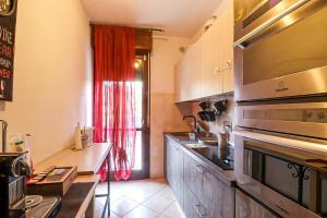 a kitchen with a sink and a stove top oven at Casa Elia in Reggio Emilia
