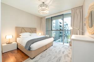 a bedroom with a bed and a large window at FAM Living City Walk - Opposite City Walk Mall - 2A in Dubai