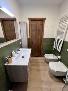 a bathroom with a sink and a toilet and a mirror at Ski House Courmayeur in Courmayeur