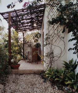 un patio con pérgola, mesa y sillas en Casa Papoula, en São Brás de Alportel