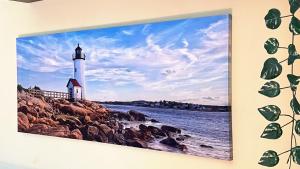 a painting of a lighthouse on a wall at Brain Residence Laceno in Villaggio Laceno