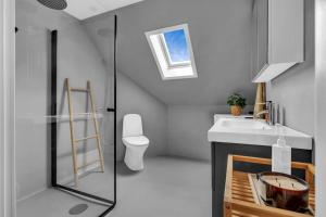 a bathroom with a sink and a toilet at Luxurious Penthouse in the Middle of City Center in Bergen