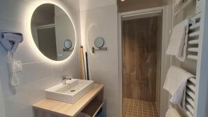 a bathroom with a sink and a mirror and a shower at La Vigie Vacances in Les Sables-dʼOlonne +62 photos