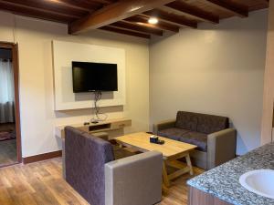 Una sala de estar con dos sillas y un televisor. en Studio Apartment, en Katmandú