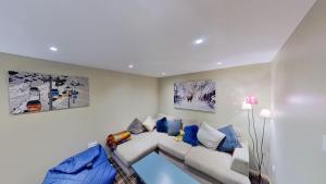 sala de estar con sofá y almohadas azules en Le Chalet des Ours en Châtel