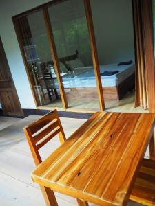 a wooden bench sitting in front of a window at Meexok river view in Nongkhiaw