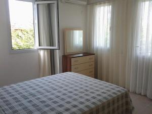 a bedroom with a bed and a dresser and a window at Holiday Home Turkuaz in Oludeniz