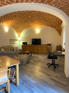 a living room with a couch and a table at Al Canun di Casale Monferrato in Casale Monferrato