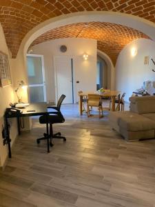 a living room with a table and a couch at Al Canun di Casale Monferrato in Casale Monferrato