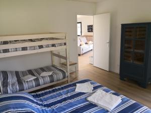a bedroom with two bunk beds and a living room at Gîtes des Embruns in Agon Coutainville