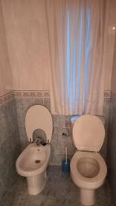 a bathroom with a toilet and a bidet at Peñazcal casita feliz in Bilbao