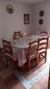 a dining room table with chairs and a table at Peñazcal casita feliz in Bilbao