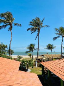 a view of the beach from a resort with palm trees at Pousada Villa Kite Flecheiras in Trairi