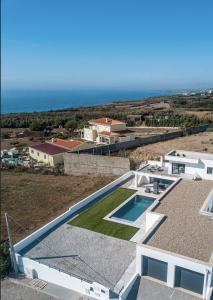 an aerial view of a house with a swimming pool at Villa Locki in Lourinhã