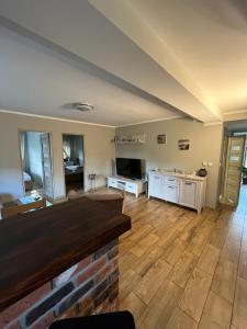 duży salon z drewnianą podłogą i kuchnią w obiekcie Ferienwohnung Anna Swinemünde Rycerska w Świnoujściu