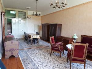 a living room filled with furniture and a table at Gutshaus Alt-Krassow in Lalendorf
