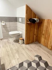 a bathroom with a toilet in a room at Studio neuf, au calme in Lorcy