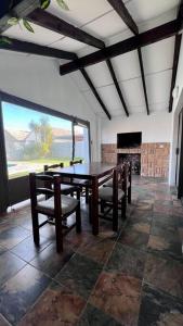 a dining room with a table and chairs and a fireplace at Family Holiday Home Rental in Port Elizabeth in Lorraine