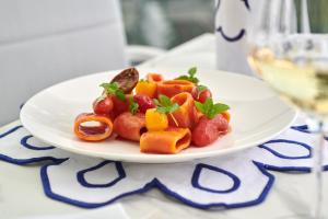 a plate of fruit and vegetables on a table at Hotel Scalinatella in Capri