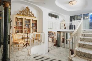 a home library with a staircase and a table and chairs at Hotel Scalinatella in Capri