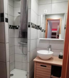 a white bathroom with a sink and a shower at terrasses du Morel in La Lechere