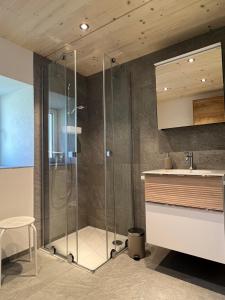 a bathroom with a shower and a sink at Ferienhaus Capricorn **** in Saas-Grund