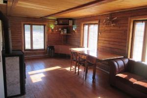 a dining room with a table and chairs in a cabin at Krustceles in Baltinava