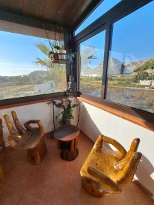 a room with two chairs and a table and a window at La Foggia seaside paradise in Siculiana