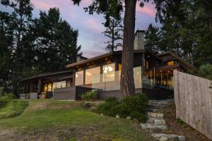 a house with large windows and a fence at Island Luxury Oceanside Estate in Saanichton