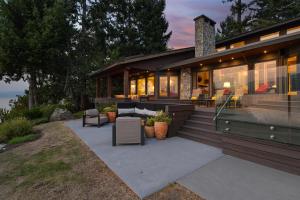 a home with a patio and a house at Island Luxury Oceanside Estate in Saanichton