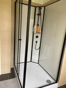 a shower with a glass door in a bathroom at near Düsseldorf Messe and Airport, two Bedrooms, Parking, Kitchen and Garden in Duisburg