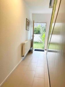 a hallway with a tile floor in a house at near Düsseldorf Messe and Airport, two Bedrooms, Parking, Kitchen and Garden in Duisburg