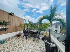 a patio with a table and chairs on a balcony at Kim Villa Swan Bay - Zone 8 in Phước Lý