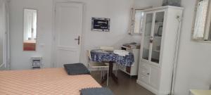 a bedroom with two beds and a desk in it at Casa ALFONSINA in Viareggio